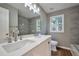 Bright bathroom with double sinks, updated fixtures, and a large mirror at 3650 Clovis Nw Ct, Atlanta, GA 30331