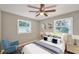 Comfortable bedroom with neutral colors, a plush bed, and two windows for natural light at 3650 Clovis Nw Ct, Atlanta, GA 30331