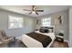 Staged bedroom featuring a comfortable bed, stylish decor, and hardwood floors at 3650 Clovis Nw Ct, Atlanta, GA 30331