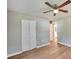 Bedroom featuring wood floors, closet access and a ceiling fan at 3650 Clovis Nw Ct, Atlanta, GA 30331