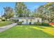 Charming single-story home features a cozy carport and well-manicured front lawn with lush greenery at 3650 Clovis Nw Ct, Atlanta, GA 30331