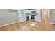 Modern kitchen with stainless steel appliances and white cabinetry, complemented by new wood floors at 3650 Clovis Nw Ct, Atlanta, GA 30331
