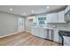 Bright and modern kitchen featuring white cabinets, stainless steel appliances, and stylish countertops at 3650 Clovis Nw Ct, Atlanta, GA 30331