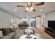 Open-concept living room, dining area, and kitchen featuring wood floors and modern design at 3650 Clovis Nw Ct, Atlanta, GA 30331