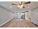 Open-concept living room, dining area, and kitchen featuring wood floors and modern design at 3650 Clovis Nw Ct, Atlanta, GA 30331
