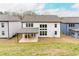 This home features a large backyard with a covered patio, perfect for outdoor entertaining at 3681 Deaton Trl, Buford, GA 30519