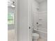 Clean bathroom with a shower/tub and view of the bedroom through doorway at 3681 Deaton Trl, Buford, GA 30519