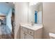 Modern half bathroom featuring a white vanity, sink, and mirror, located off the hallway at 3681 Deaton Trl, Buford, GA 30519