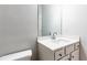 Bathroom features a single sink vanity with storage and a mirror at 3681 Deaton Trl, Buford, GA 30519