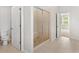 Modern bathroom with a glass-enclosed shower featuring pebble floor and a tiled shower at 3681 Deaton Trl, Buford, GA 30519
