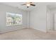 Sunny bedroom with carpet and a large window overlooking the neighborhood at 3681 Deaton Trl, Buford, GA 30519