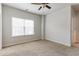 Bedroom features light carpet, a ceiling fan, and a large window at 3681 Deaton Trl, Buford, GA 30519