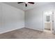 Bedroom with light carpet, a ceiling fan, and attached bathroom at 3681 Deaton Trl, Buford, GA 30519