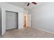 Neutral bedroom with light carpet, ceiling fan, and open closet at 3681 Deaton Trl, Buford, GA 30519