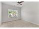 Bedroom features a large window that lets in natural light and a ceiling fan at 3681 Deaton Trl, Buford, GA 30519
