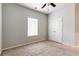 Bedroom featuring neutral carpet, a ceiling fan, and a window, along with a closet at 3681 Deaton Trl, Buford, GA 30519