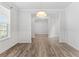 Elegant dining room area featuring hardwood floors, a modern light fixture, and detailed molding at 3681 Deaton Trl, Buford, GA 30519