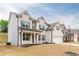 Beautiful two-story brick home featuring a covered front porch and attached two-car garage at 3681 Deaton Trl, Buford, GA 30519