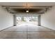 This is a two car garage with concrete flooring and an open garage door at 3681 Deaton Trl, Buford, GA 30519
