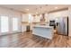 Bright kitchen boasts stainless steel appliances, island, and sleek countertops at 3681 Deaton Trl, Buford, GA 30519