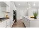 Modern kitchen with white cabinets, stainless appliances, a center island, and stylish pendant lights at 3681 Deaton Trl, Buford, GA 30519