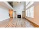 Cozy living room with a fireplace, soaring ceilings, and large windows at 3681 Deaton Trl, Buford, GA 30519