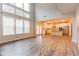 Spacious open-concept living area with hardwood floors and an adjacent kitchen at 3681 Deaton Trl, Buford, GA 30519
