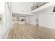 Spacious open-concept living area with hardwood floors, adjacent to a bright kitchen with modern appliances and an island at 3681 Deaton Trl, Buford, GA 30519