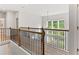 Second story loft space with hardwood floors, natural lighting, and black metal railing at 3681 Deaton Trl, Buford, GA 30519