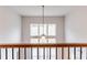 Open loft area with a view of the ceiling fan and windows, showcasing modern home architectural design at 3681 Deaton Trl, Buford, GA 30519
