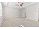 Spacious main bedroom featuring plush carpeting, a ceiling fan, and recessed lighting at 3681 Deaton Trl, Buford, GA 30519
