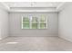 Spacious main bedroom features large windows, neutral carpeting, and tray ceiling at 3681 Deaton Trl, Buford, GA 30519