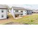 View of the home's rear exterior with covered patio and well-kept backyard at 3681 Deaton Trl, Buford, GA 30519