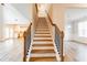 Inviting staircase with hardwood steps, wrought iron railings, and natural light at 3681 Deaton Trl, Buford, GA 30519