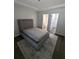 Bedroom showcasing a neutral palette, including a gray bed and a coordinating patterned rug at 434 Bentley Place, Tucker, GA 30084