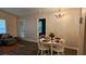 Open concept living and dining area with a round table with seating for four, chandelier and wood-look flooring at 434 Bentley Place, Tucker, GA 30084