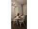 The dining area features a round table with seating for four, chandelier and wood-look flooring at 434 Bentley Place, Tucker, GA 30084