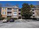 Multi-story condo building with balconies and well-maintained landscaping at 434 Bentley Place, Tucker, GA 30084