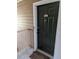 A close-up of front door 434 with dark green paint, a decorative knocker, and a white door frame at 434 Bentley Place, Tucker, GA 30084