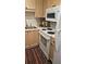 The kitchen features wood cabinets, stainless steel sink, stove and oven combo and a microwave at 434 Bentley Place, Tucker, GA 30084
