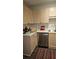 Kitchen showcasing stainless steel dishwasher and wooden cabinets at 434 Bentley Place, Tucker, GA 30084