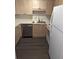A compact kitchen boasts stainless appliances, light wood cabinetry, and a sleek dark floor at 434 Bentley Place, Tucker, GA 30084