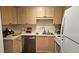 Kitchen featuring wood cabinets, stainless steel dishwasher, and modern appliances at 434 Bentley Place, Tucker, GA 30084