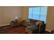Cozy living room featuring a comfortable couch with decorative pillows and natural light from the window at 434 Bentley Place, Tucker, GA 30084