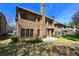 Exterior view of a brick home with backyard patio, lawn and landscaping at 4782 Lakeway, Alpharetta, GA 30005