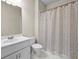 Bathroom featuring a sink, toilet, and shower with a curtain with a floral pattern at 4782 Lakeway, Alpharetta, GA 30005