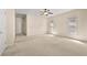 Light-filled bonus room featuring a fan, neutral carpet, two windows, and a white door at 4782 Lakeway, Alpharetta, GA 30005