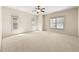 Large bonus room with neutral carpeting, white walls, a fan and three windows at 4782 Lakeway, Alpharetta, GA 30005