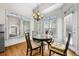 Cozy breakfast nook bathed in natural light, featuring hardwood floors and a chandelier at 4782 Lakeway, Alpharetta, GA 30005
