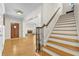 A view of the foyer showing hardwood steps, chandelier, and entry door at 4782 Lakeway, Alpharetta, GA 30005